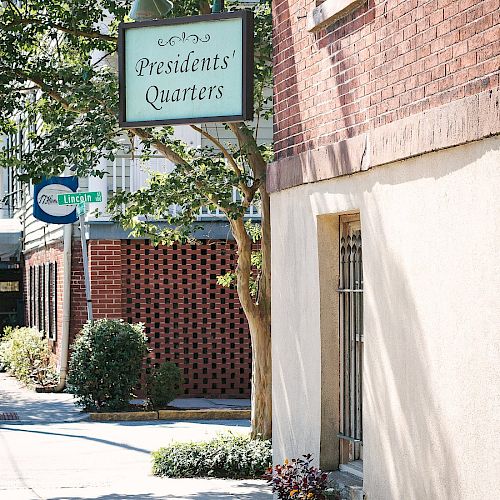 The image shows a brick building with a sign that reads 